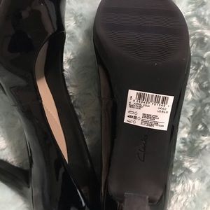Clark’s black patent leather pumps